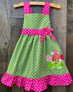 This cute custom boutique Strawberry Shortcake birthday girl dress would be perfect to wear for your little girls Strawberry Shortcake Birthday theme party. This dress is nice and comfy, lime and pink polka dot jumper style. Your baby girl will love playing dress up and twirling around in this Strawberry Shortcake dress on her special day. Please check out Lil' Bug Clothing for a wide range of more Strawberry Shortcake outfits and dresses. Cute Polka Dot Dress For Birthday, Spring Birthday Green Dress, Cute Green Easter Dress, Green Fitted Dress For First Birthday, Green Ruffled Dress For First Birthday, Cute Green Dresses For Birthdays, Cute Green Dress For First Birthday, Green Whimsical Dress For Birthday, Whimsical Green Dress For Birthday