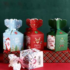 several wrapped presents sitting on top of a red table