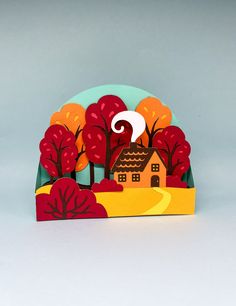 a card with a house and trees on it