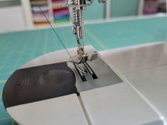 the sewing machine is on top of the quilting pad and it's needle has been sewn