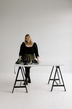 a woman standing at a table with some equipment on it