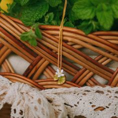 Lemon Necklace with a small lemon pendant look very nice. It can be worn with other 18k gold simple chains. This lemon necklace is fruit jewelry from Selenichast jewelry store.
 A delicate golden necklace that is adorned with lifelike lemon slice pendant gives us delight in its bucolic atmosphere. An enamelled lemon slice dotted with green leaves in its right hand corner presents unspeakable loveliness and agreeable sweetness. A clever choice for women to light up everyday outfits. 
 DETAILS Yellow Gold Plated Necklace With Flower Charm, Delicate Handmade Yellow Gold Charm Necklace, Gold Plated Pendant Necklace With Flower Charm, Delicate Yellow Gold Charm Necklace With Clavicle Chain, Delicate Yellow Gold Charm Necklaces With Clavicle Chain, Dainty Gold Plated Necklace With Flower Charm, Dainty Yellow Gold Necklace With Flower Pendant, Dainty Yellow Gold Charm Necklace With Flower Shape, Gold Plated Necklace With Flower Charm