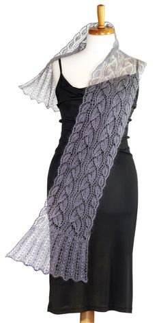 a knitted shawl on top of a mannequin's dummy wearing a black dress