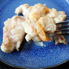 a blue plate topped with shrimp and gravy