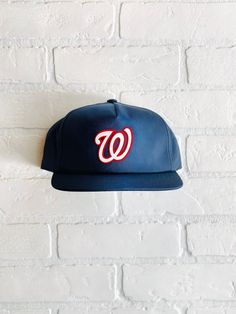 Vintage Washington Nationals Hat - (New) Unstructured 5 Panel Snapback in NavyClosure - 7 Button Plastic SnapColor - NavyConstruction - 6 Panel SnapbackContents - 60% Cotton / 40% PolyesterProfile - 3.25"Size - One Size Fits All (6 ⅝” – 7 ⅝”)Structure - Lightly Structured- Flocked Nationals Patch Dodger Hats, Chicago Gifts, Cubs Hat, Different Hats, Washington Nationals, Quality Hats, Philadelphia Phillies, Custom Hats, Snapback Hat