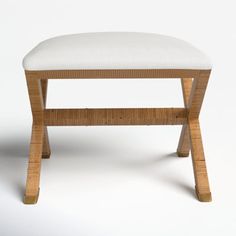 an upholstered wooden bench with white fabric