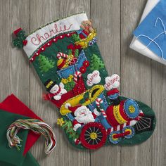 a christmas stocking with santa on it next to candy canes and other holiday decorations