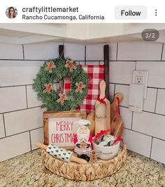 a kitchen counter with christmas decorations on it and a wooden sign that says merry christmas