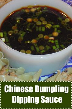 chinese dumpling dipping sauce in a white bowl on top of noodles and green onions