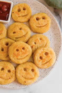 a white plate topped with smiley face cookies