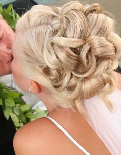 a bride kissing her groom on the cheek