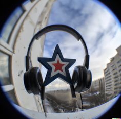 a pair of headphones with a star on the front and earbuds attached to it