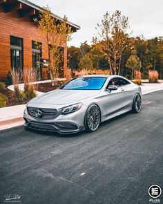 a silver car parked in front of a building