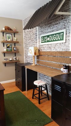 a room with a brick wall and wooden flooring has a green rug on the floor