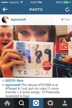 a woman holding up a tweet that reads taylor swift like the deluxe ts1998 is at target & i just got my copy 3 copies