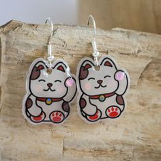 Take luck and love with you where ever you go with this sweet lucky cat! <3  Hypoallergenic metal to provide the utmost comfort! <3 These earrings would be great for a music festival or any music event! <3 Handmade by yours truly <3 Out of Shrinky Dink Film <3 White Cat Design Earrings For Gift, White Cat Design Earrings As A Gift, White Cat Design Earrings As Gift, Cute Cat Ears Earrings With Cat Print, Cute Cat Design Adjustable Earrings, Cute Cat Print Jewelry Gift, Adjustable Cute Cat Design Earrings, Cute Adjustable Cat Design Earrings, Kawaii Hypoallergenic Earrings As Gift