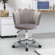 an office chair with wheels in front of a desk