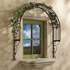 an arched window with vines on the outside