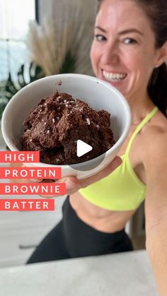 a woman holding a bowl of brownie batter in her hand with the words high protein brownie batter on it