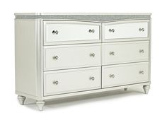 a white dresser with drawers and marble top on it's sides, against a white background