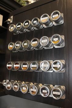 several different types of coffee cups are on the wall in front of a display case