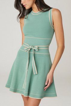 Cute sleeveless knit mini dress. This style features a crew neckline, fitted bodice, wide rib waistband with a thin tie belt, and a flared A-line mini skirt. Contrast tipping along the crew neckline, armholes, waistband, tie belt, and skirt hem. Unlined. Slip on. 65% Rayon, 35% Nylon. Dry clean only.  Color: Pistachio/Camel Dresses With Belts, All Green Outfit, Africa Trip, American Dress, A Line Mini Skirt, Sleeveless Knit, Easy Trendy Outfits, Mini Slip Dress, Ribbed Dresses