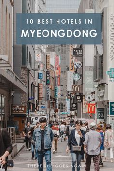 people walking down the street in front of buildings with text overlay that reads 10 best hotels in myeongdong