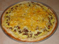 a cheesy pizza sitting on top of a pan covered in cheese and meat