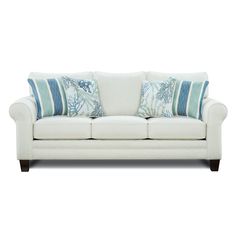 a white couch with blue and green pillows