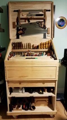 a large wooden box with lots of tools in it