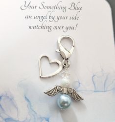 a card with an angel charm attached to it