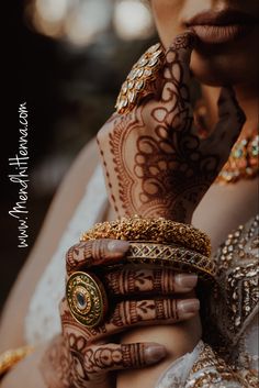 a close up of a person with henna on their hands