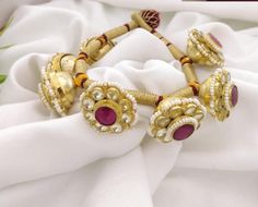 Kundan Pochi Bracelet/ Designer Rajwadi Bracelet/ Rajput Pochi Bracelet/ Jaipuri Bridal Gold Openable Bracelet/ Ruby Vintage Bracelet Features Traditional Ruby/Kundan/Polki/Jadau Bracelet Designer Vintage Bracelet in Red Ruby crystals, Kundan Jadau work Handcrafted To Perfection Light Weight Perfect For Indian Weddings And Celebrations A Beautiful & Memorable Gift for Weddings and Special Occasions Suitable for any traditional attire Fits 2.6 and 2.8 size Openable Bracelet with loop closure The Traditional Adjustable Kundan Necklace With Latkans, Traditional Adjustable Kundan Necklace For Puja, Adjustable Kundan Necklace With Latkans For Festivals, Traditional Adjustable White Kundan Necklace, Festive Celebration Bracelets With Latkans, White Tilla Bracelets For Ceremonial Occasions, Traditional Latkans Bracelets For Diwali, White Ceremonial Bracelets With Tilla Detail, Traditional White Bracelets For Celebration