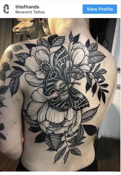 the back of a woman's body with flowers on it and an instagram