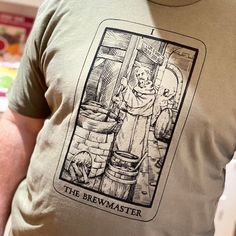 a man wearing a t - shirt with an image of a bear in the barrel