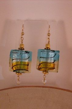 Beautiful aqua, gold and black striped square glass bead earrings accented with crystals.   Beads are 3/4 x 3/4 inches. 14K Gold Filled ear wires. Crystals Beads, Glass Bead Earrings, Bead Earrings, Lebanon, Glass Bead, Ear Wires, Black Stripes, Beaded Earrings, Square Glass