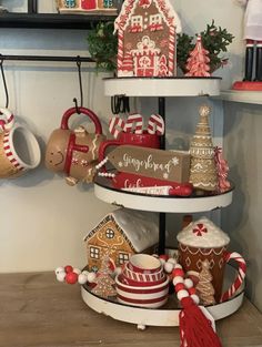 three tiered trays filled with gingerbread houses and candy canes for christmas