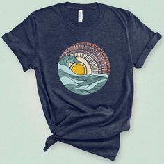 Catch a wave of happiness with a peak of a pastel sunset through a retro boho styled barrel wave. This super soft surf style graphic tee is perfect for a casual day at the beach or nod to California beach style. Made from luxurious Airlume combed and ring-spun cotton, our Classic Cut tee fits like a well-loved favorite the moment you put it on. Its tailored fit and classic crew neck design offer effortless style, while ethical manufacturing adds a touch of sustainability. Versatile and comfortab California Beach Style, Style Graphic Tee, Pastel Sunset, Cut Tees, California Beach, Surf Style, Surfer Girl, Graphic Tees Women, Beach Style