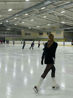 people skating on an indoor ice rink in winter