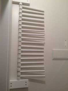 a white radiator mounted to the side of a wall next to a light switch