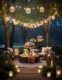 an outdoor seating area with candles and flowers on the table, surrounded by greenery