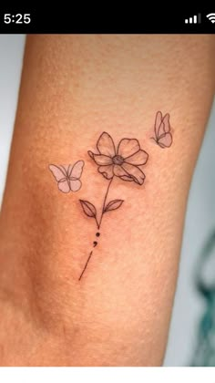 a small tattoo with flowers and butterflies on the side of her leg, which is shown in