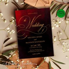 the wedding card is laying on top of some flowers