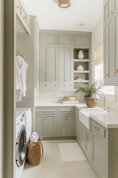 a washer and dryer in a very large room with lots of cupboards