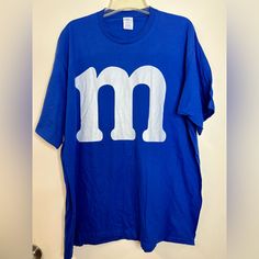 Blue M&M Funny Halloween T-Shirt Perfect For A Halloween Costume! Brand New But No Tags 100% Cotton Inventory A Halloween Blue Tops With Letter Print, Blue Halloween Top With Letter Print, Blue Halloween Tops With Letter Print, Blue Letter Print Top For Halloween, Blue Halloween Letter Print Tops, Blue T-shirt For Fall Streetwear, Blue Pre-shrunk Tops For Halloween, Blue Pre-shrunk T-shirt For Fall, Blue Screen Print T-shirt For Fall