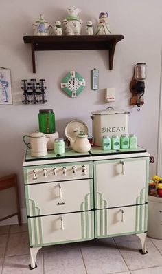 an old fashioned stove with many pots and pans on it's top shelf