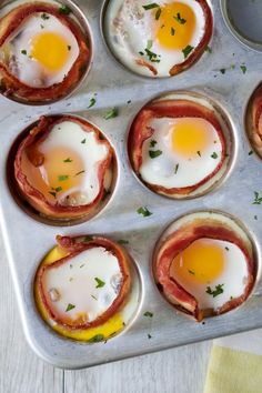 some eggs and bacon are in a muffin tin