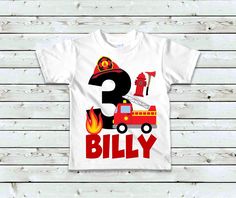 a white shirt with a fire truck and number three on it