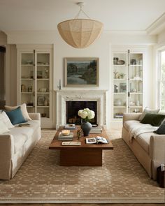 a living room filled with furniture and a fire place