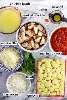 ingredients to make chicken parmesan pasta on a marble counter top